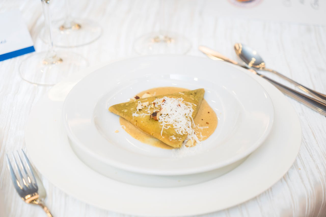 Delicious gourmet dish served elegantly with cheese garnish, perfect for culinary enthusiasts.